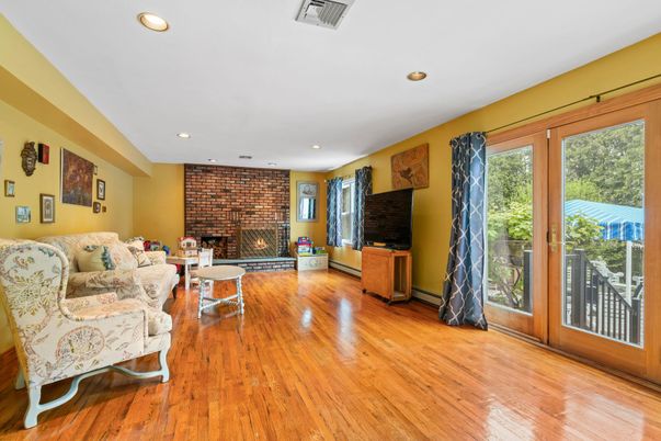 Fireplace, Interior, Living room, Recessed Lighting, Stone Walls, Wood Texture Flooring