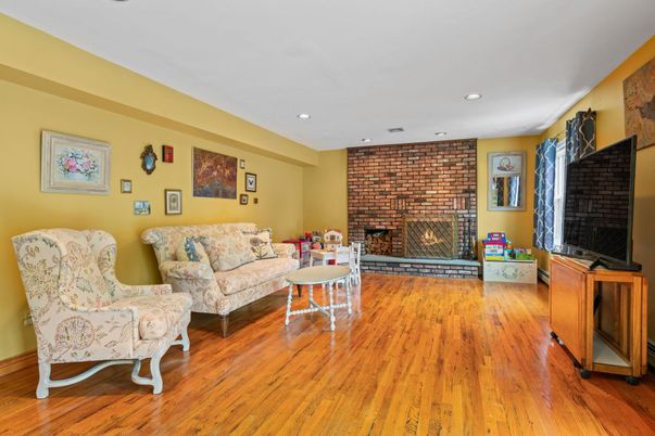 Fireplace, Interior, Living room, Recessed Lighting, Stone Walls, Wood Texture Flooring