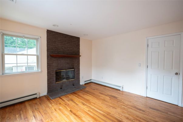 Empty room, Fireplace, Interior, Recessed Lighting, Stone Walls, Wood Texture Flooring