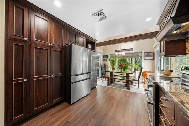 Chandelier, Dining room, Interior, Kitchen, Pendant Lights, Recessed Lighting, Stainless Steel Appliances, Wood Texture Flooring