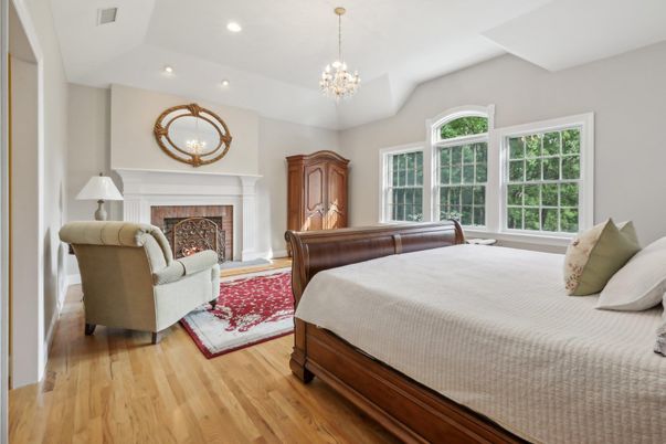 Bedroom, Chandelier, Fireplace, Interior, Recessed Lighting, Wood Texture Flooring