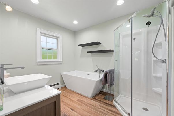 Bathroom, Free Standing Baths, Glass Shower, Interior, Recessed Lighting, Wood Texture Flooring