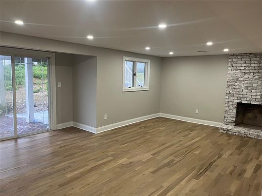 Empty room, Fireplace, Interior, Recessed Lighting, Stone Walls, Wood Texture Flooring