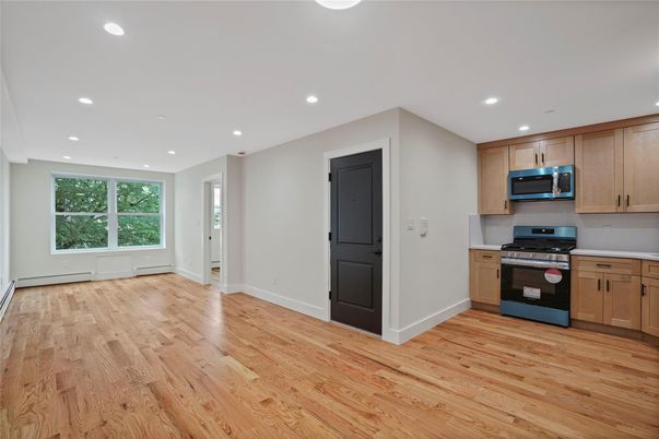 Empty room, Interior, Kitchen, Recessed Lighting, Stainless Steel Appliances, Wood Texture Flooring