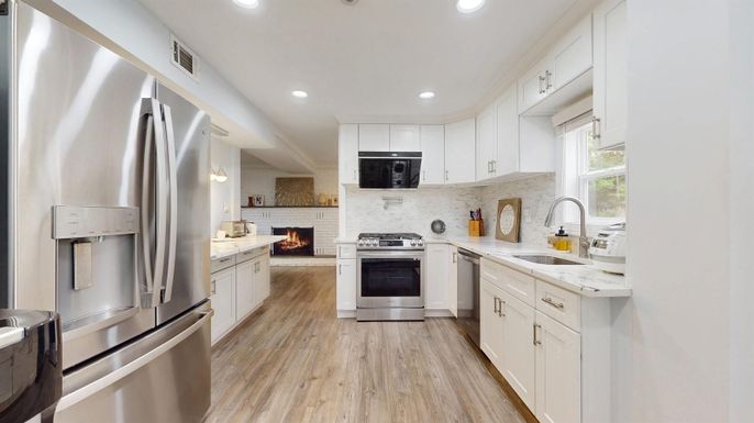 Fireplace, Interior, Kitchen, Recessed Lighting, Stainless Steel Appliances, Wood Texture Flooring