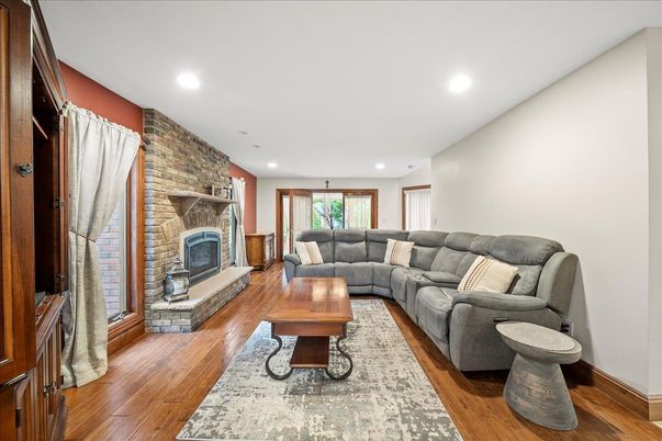 Fireplace, Interior, Living room, Recessed Lighting, Stone Walls, Wood Texture Flooring