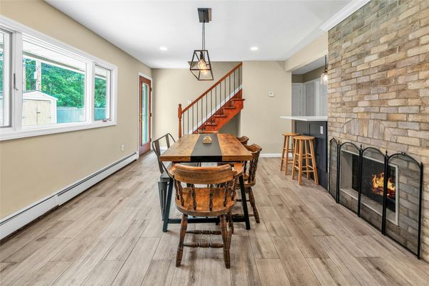 Dining room, Fireplace, Interior, Pendant Lights, Recessed Lighting, Stone Walls, Wood Texture Flooring