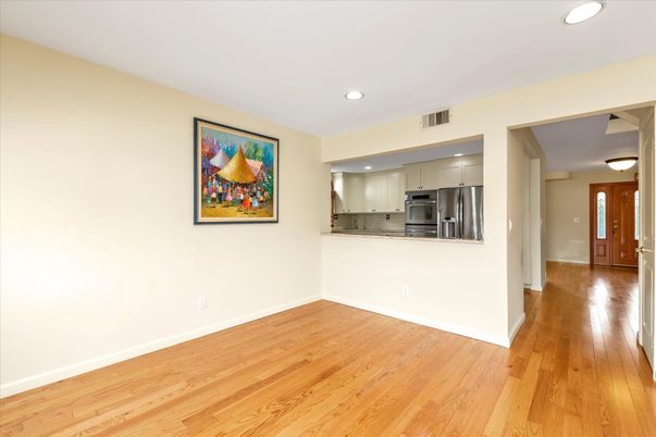 Empty room, Interior, Kitchen, Recessed Lighting, Stainless Steel Appliances, Wood Texture Flooring