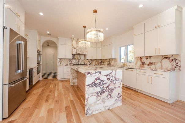 Chandelier, Interior, Kitchen, Marble Walls, Pendant Lights, Recessed Lighting, Stainless Steel Appliances, Wood Texture Flooring