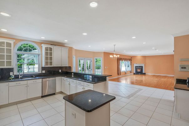 Chandelier, Fireplace, Interior, Kitchen, Recessed Lighting, Stainless Steel Appliances, Wood Texture Flooring
