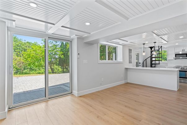 Empty room, Interior, Kitchen, Pendant Lights, Recessed Lighting, Stainless Steel Appliances, Wood Texture Flooring