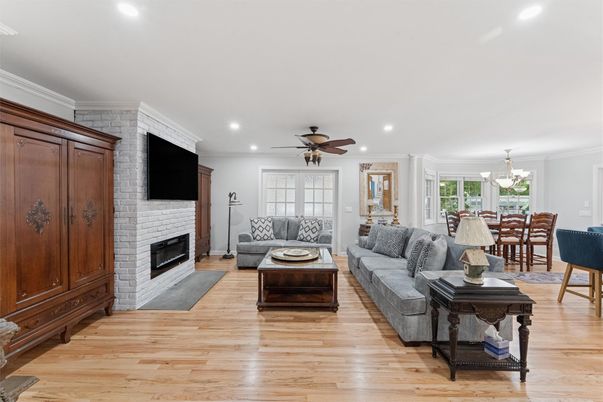 Chandelier, Dining room, Fireplace, Interior, Living room, Recessed Lighting, Stone Walls, Wood Texture Flooring