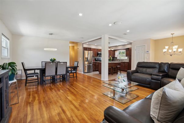 Chandelier, Dining room, Interior, Kitchen, Living room, Pendant Lights, Recessed Lighting, Stainless Steel Appliances, Wood Texture Flooring