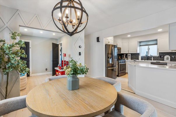 Chandelier, Dining room, Interior, Kitchen, Recessed Lighting, Stainless Steel Appliances, Wood Texture Flooring