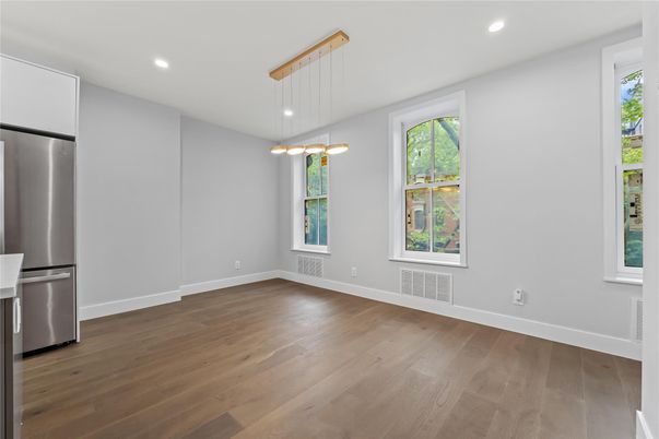 Empty room, Interior, Kitchen, Pendant Lights, Recessed Lighting, Stainless Steel Appliances, Wood Texture Flooring