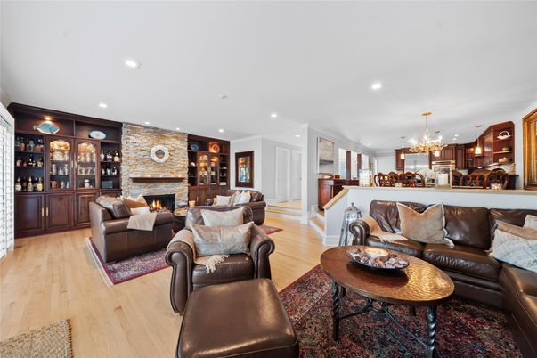 Chandelier, Fireplace, Interior, Living room, Recessed Lighting, Stone Walls, Wood Texture Flooring