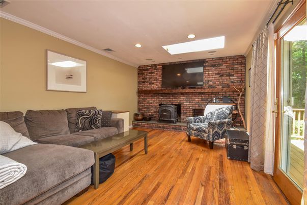Fireplace, Interior, Living room, Recessed Lighting, Stone Walls, Wood Texture Flooring