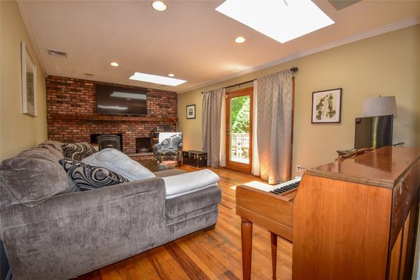 Fireplace, Interior, Living room, Piano, Recessed Lighting, Stone Walls, Wood Texture Flooring