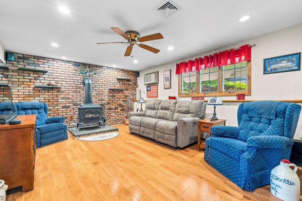 Fireplace, Interior, Living room, Recessed Lighting, Stone Walls, Wood Texture Flooring