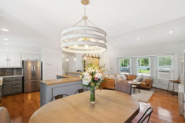 Chandelier, Dining room, Interior, Kitchen, Living room, Pendant Lights, Recessed Lighting, Stainless Steel Appliances, Wood Texture Flooring