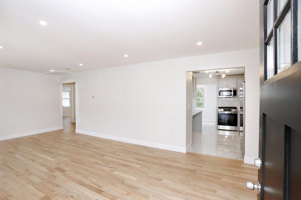 Empty room, Interior, Kitchen, Recessed Lighting, Stainless Steel Appliances, Wood Texture Flooring