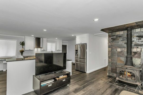 Fireplace, Interior, Kitchen, Recessed Lighting, Stainless Steel Appliances, Stone Walls, Wood Texture Flooring