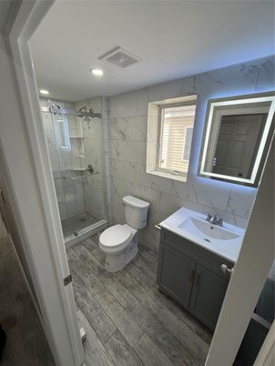 Bathroom, Glass Shower, Interior, Marble Walls, Recessed Lighting, Wood Texture Flooring