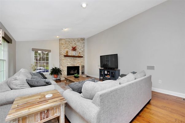 Fireplace, Interior, Living room, Recessed Lighting, Stone Walls, Wood Texture Flooring