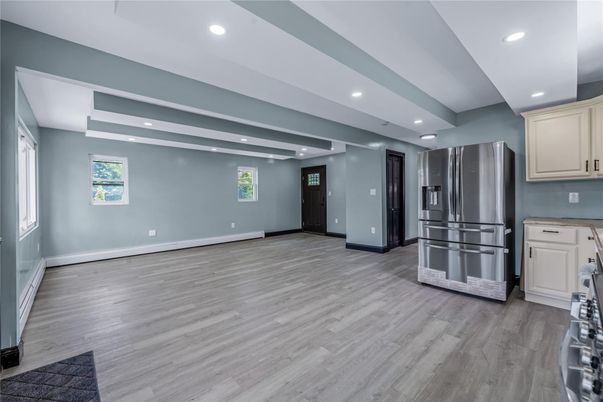 Empty room, Interior, Kitchen, Recessed Lighting, Stainless Steel Appliances, Wood Texture Flooring
