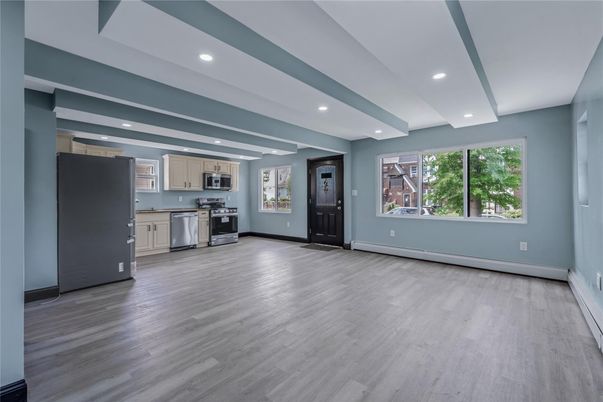 Empty room, Interior, Kitchen, Recessed Lighting, Stainless Steel Appliances, Wood Texture Flooring