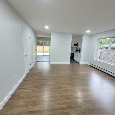Empty room, Interior, Kitchen, Recessed Lighting, Stainless Steel Appliances, Wood Texture Flooring