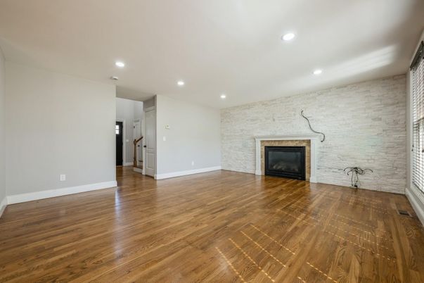 Empty room, Fireplace, Interior, Recessed Lighting, Stone Walls, Wood Texture Flooring