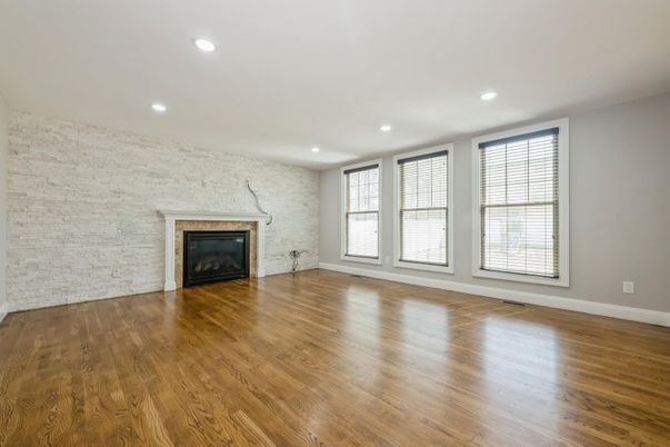 Empty room, Fireplace, Interior, Recessed Lighting, Stone Walls, Wood Texture Flooring