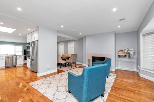 Dining room, Fireplace, Interior, Kitchen, Living room, Recessed Lighting, Stainless Steel Appliances, Wood Texture Flooring