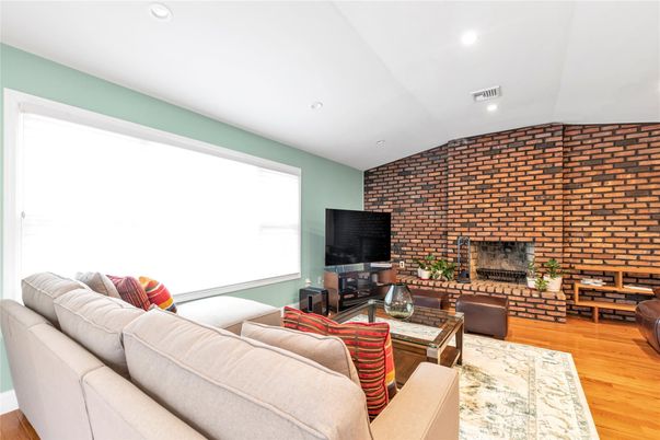 Fireplace, Interior, Living room, Recessed Lighting, Stone Walls, Wood Texture Flooring