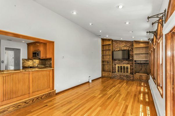 Empty room, Fireplace, Interior, Kitchen, Recessed Lighting, Stone Walls, Wood Texture Flooring