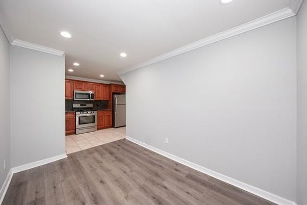 Empty room, Interior, Kitchen, Recessed Lighting, Stainless Steel Appliances, Wood Texture Flooring
