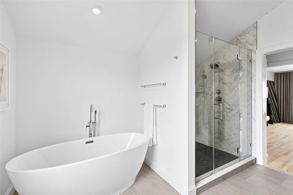 Bathroom, Free Standing Baths, Glass Shower, Interior, Marble Walls, Recessed Lighting, Wood Texture Flooring