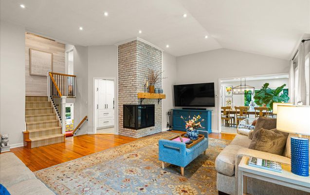 Dining room, Fireplace, Interior, Living room, Recessed Lighting, Stone Walls, Wood Texture Flooring