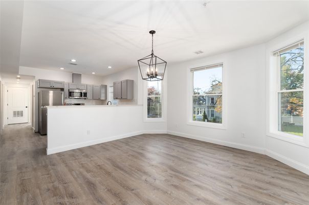 Chandelier, Empty room, Interior, Kitchen, Pendant Lights, Recessed Lighting, Stainless Steel Appliances, Wood Texture Flooring