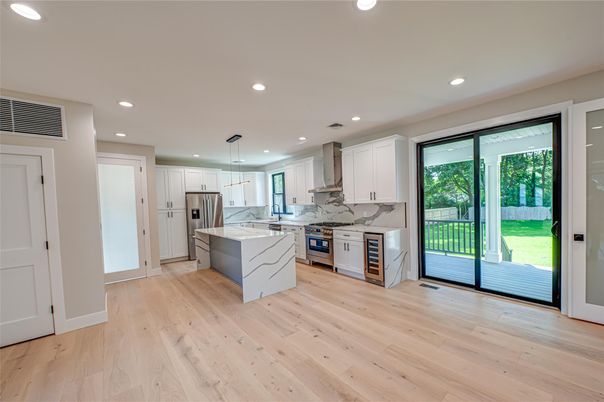 Interior, Kitchen, Marble Walls, Pendant Lights, Recessed Lighting, Stainless Steel Appliances, Wood Texture Flooring