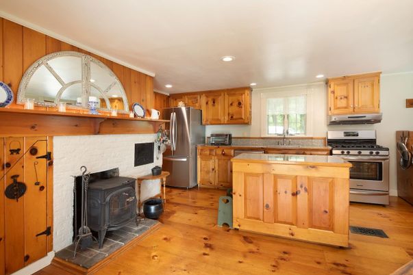 Fireplace, Interior, Kitchen, Recessed Lighting, Stainless Steel Appliances, Wood Texture Flooring