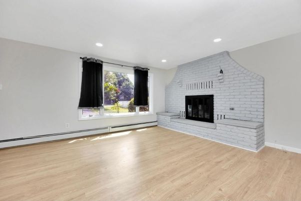 Empty room, Fireplace, Interior, Recessed Lighting, Stone Walls, Wood Texture Flooring