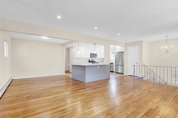 Chandelier, Empty room, Interior, Kitchen, Pendant Lights, Recessed Lighting, Stainless Steel Appliances, Wood Texture Flooring