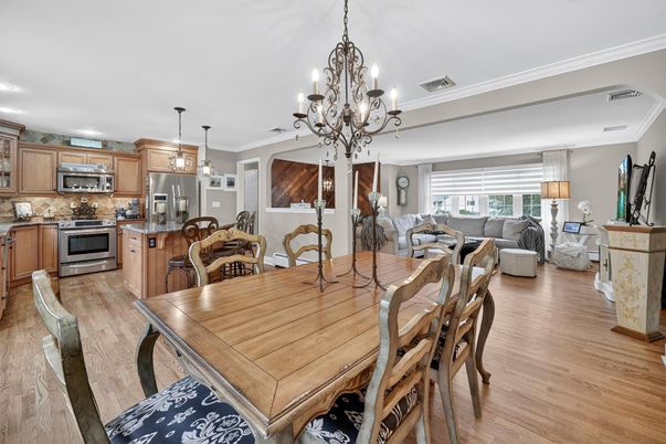 Chandelier, Dining room, Interior, Kitchen, Living room, Pendant Lights, Recessed Lighting, Stainless Steel Appliances, Wood Texture Flooring