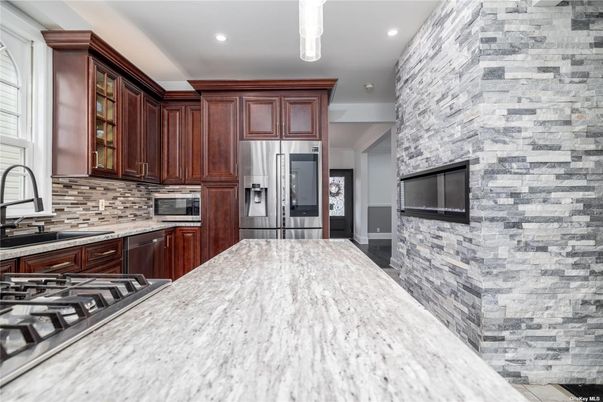Fireplace, Interior, Kitchen, Recessed Lighting, Stainless Steel Appliances, Stone Walls