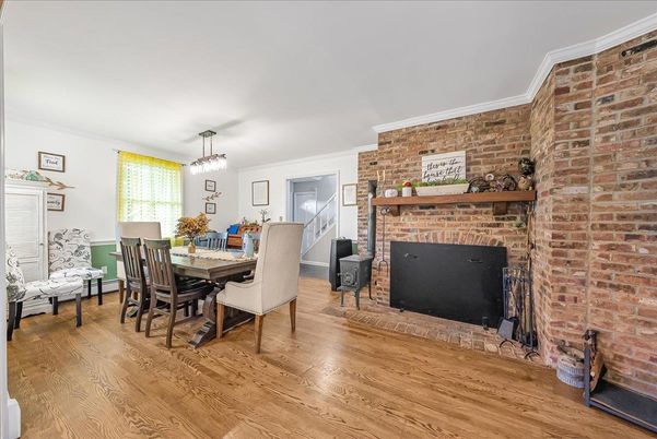 Chandelier, Dining room, Fireplace, Interior, Pendant Lights, Stone Walls, Wood Texture Flooring