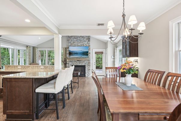 Chandelier, Dining room, Fireplace, Interior, Recessed Lighting, Stone Walls, Wood Texture Flooring
