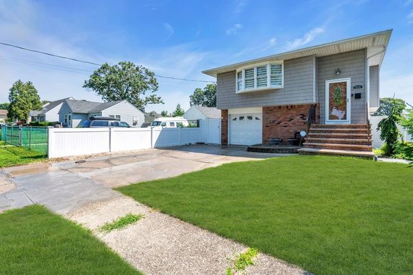 Attached, Backyard, Exterior, Facade, Brick Facade, Raised Ranch