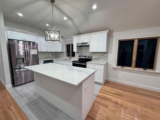 Interior, Kitchen, Marble Walls, Pendant Lights, Recessed Lighting, Stainless Steel Appliances, Wood Texture Flooring